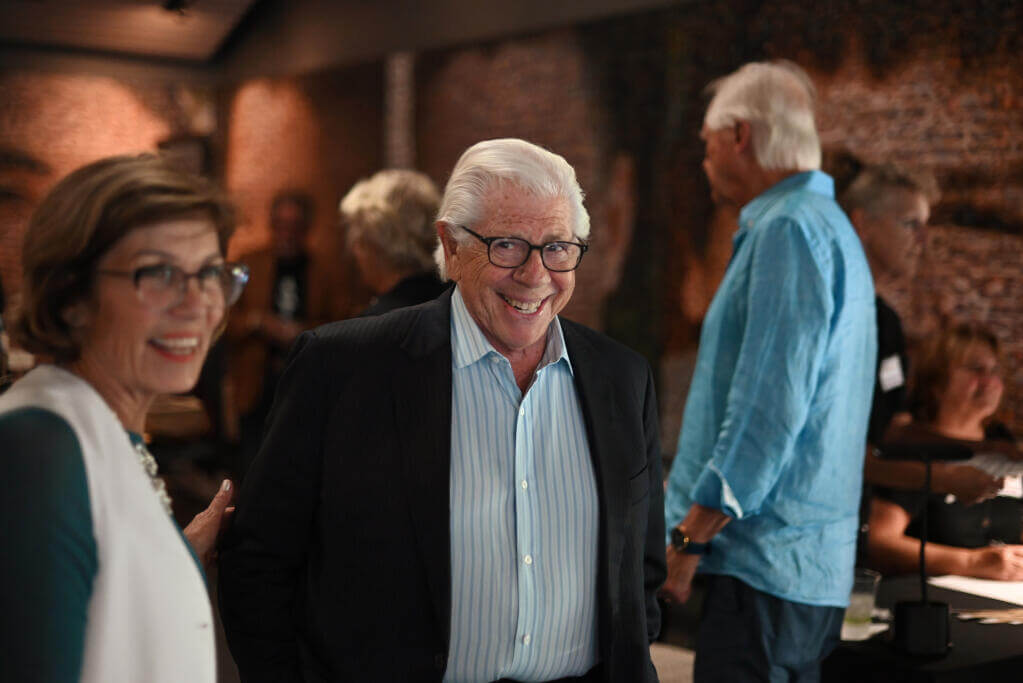 Journalist Carl Bernstein, center, was the center of attention during a brief VIP reception before his discussion with Sonoma Speaker Series Board Member Laura Zimmerman, left, at the Hanna Center in Sonoma on Monday, Aug. 19, 2024. (Erik Castro / For The Press Democrat)